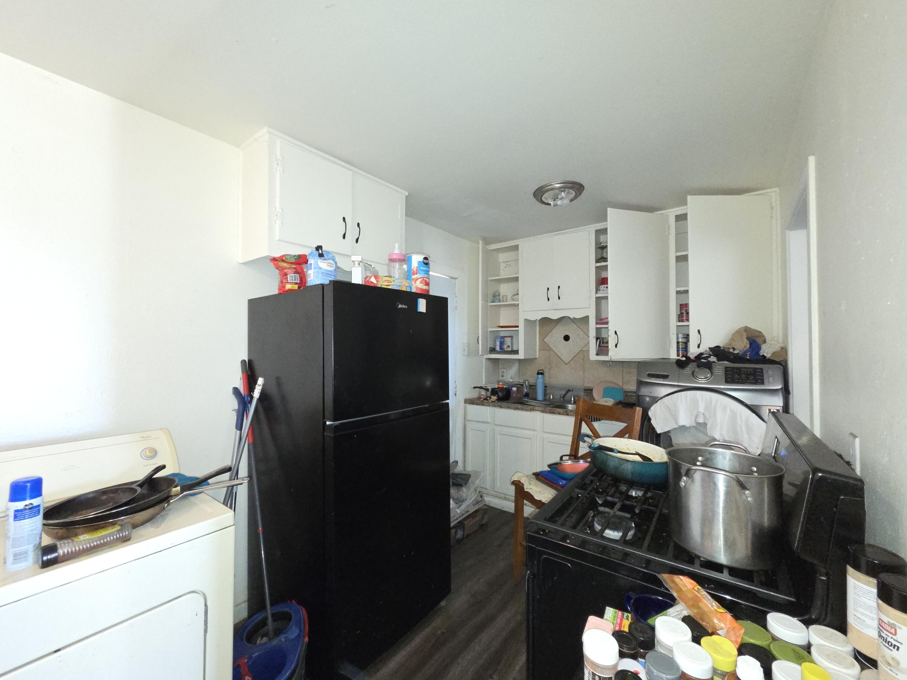 2401 East 10th Street Lubbock, TX 79403 - Photo 4 of 7 a kitchen with a refrigerator and a stove