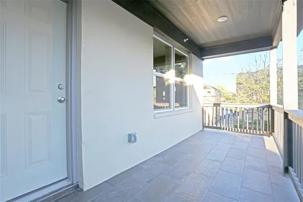 a view of a room with balcony and furniture