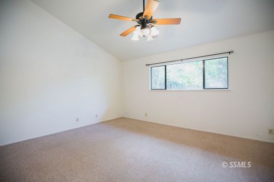 1025 Scott Street Ridgecrest, CA 93555 - Photo 9 of 29 an empty room with a window and a fan