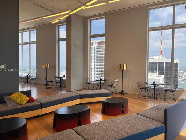 a kitchen with large windows and table