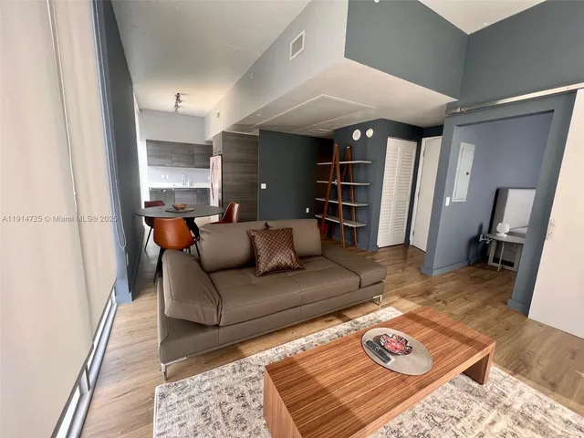 a living room with furniture and a rug