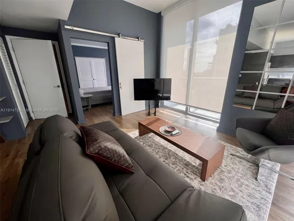 a living room with furniture and a flat screen tv