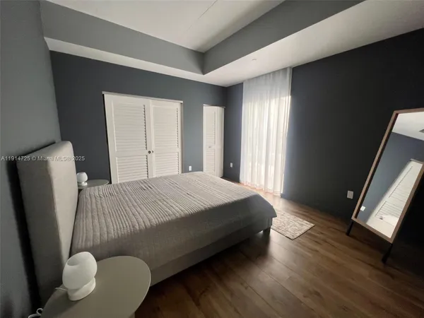 a bed sitting in a bedroom next to a window