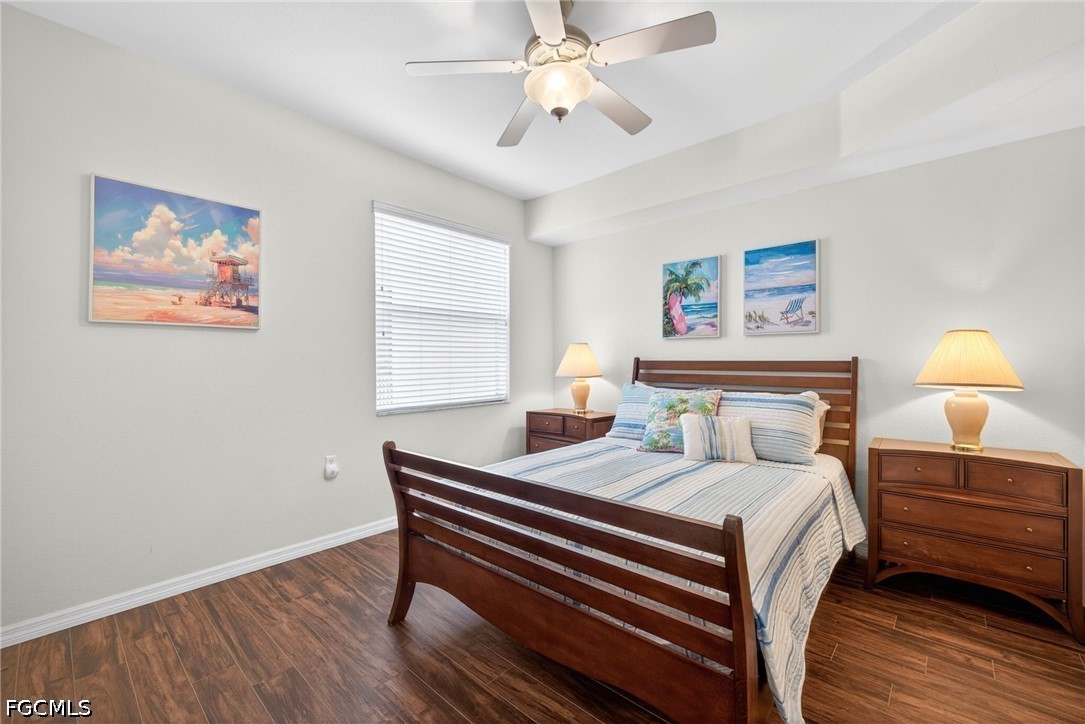 8251 Pathfinder Loop, Unit 621 Fort Myers, FL 33919 - Photo 17 of 30 a bedroom with a bed and a chandelier