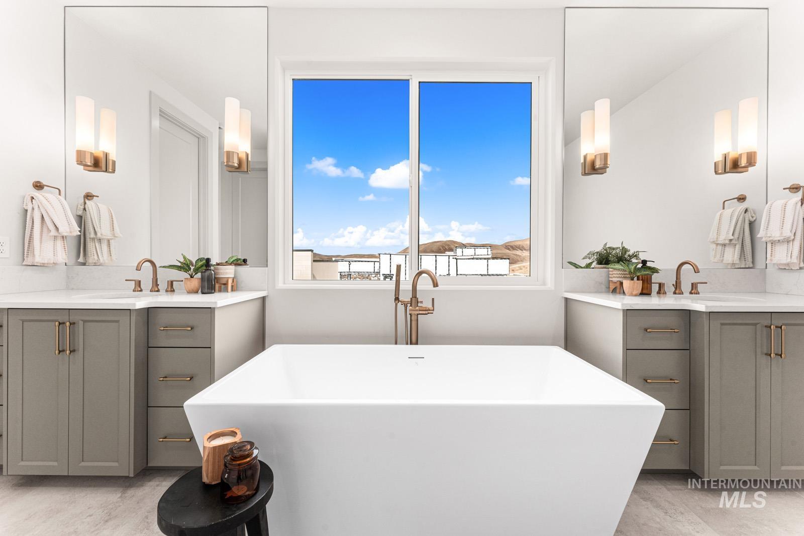 6169 East Prominence Court Boise, ID 83716 - Photo 24 of 43 Full bath featuring two vanities and a freestanding tub