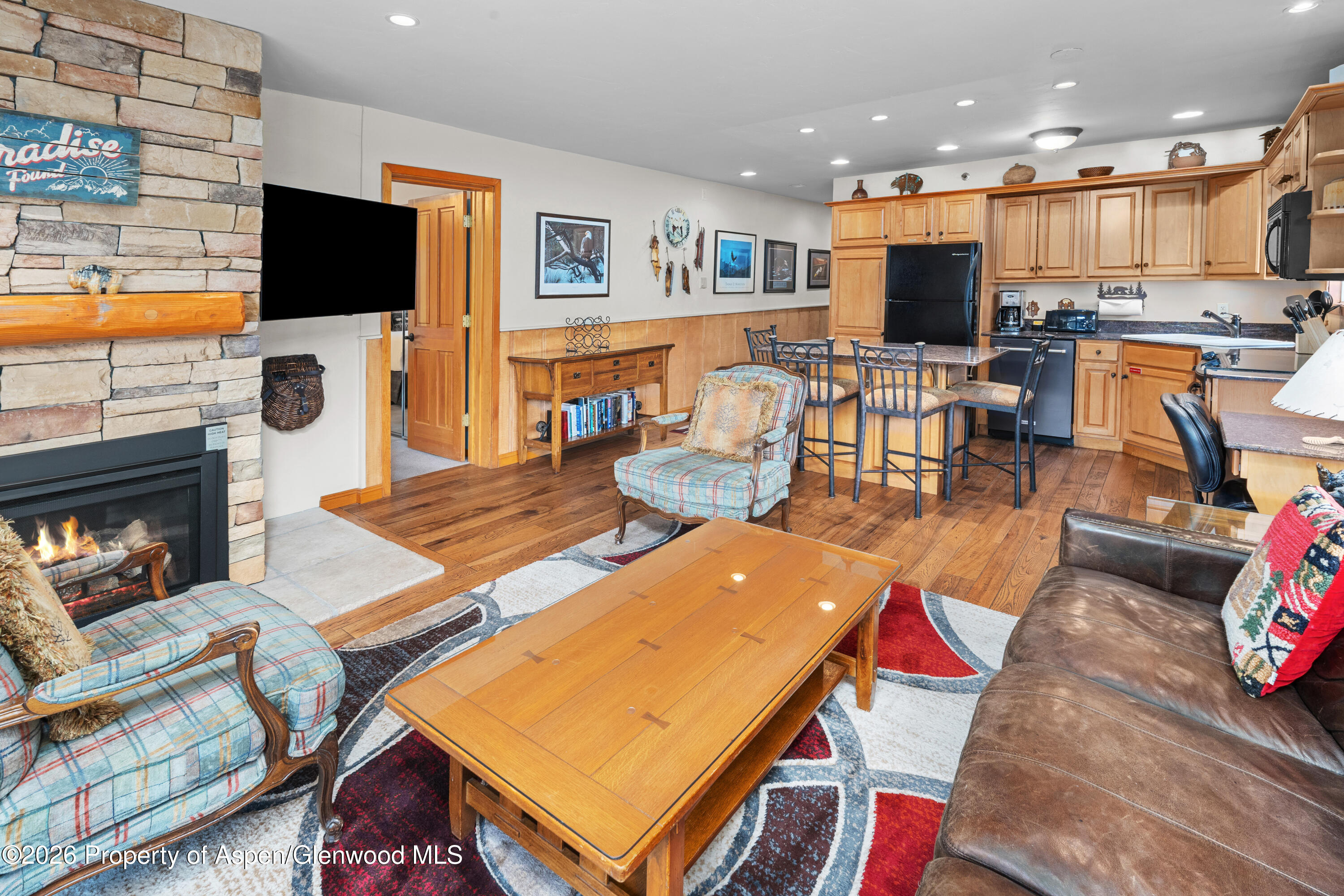 400 Wood Road, Unit 2111H Snowmass Village, CO 81615 - Photo 5 of 16 a living room with furniture and a flat screen tv