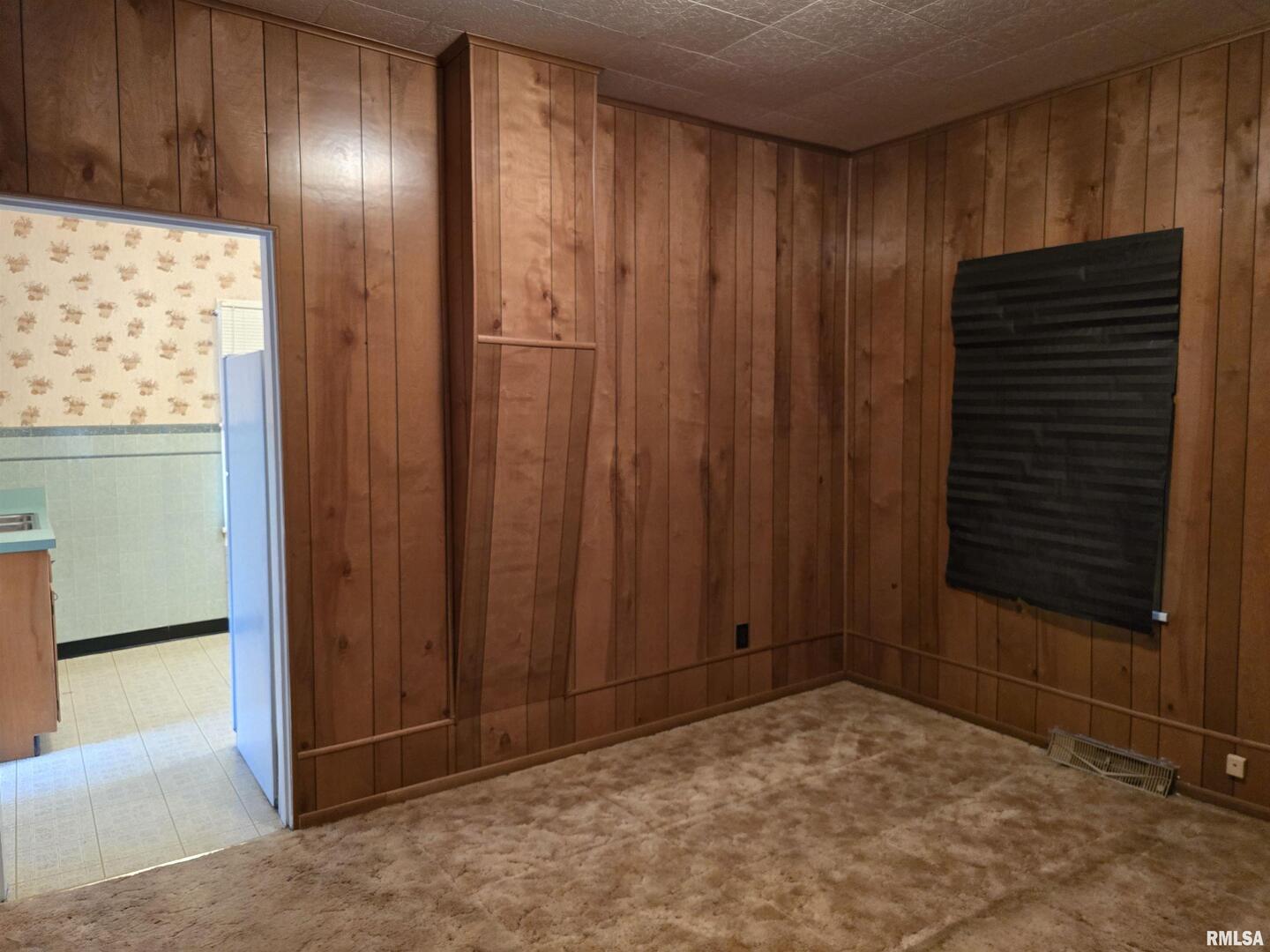 4760 Raleigh Road Eldorado, IL 62930 - Photo 14 of 19 a view of an empty room with wooden walls