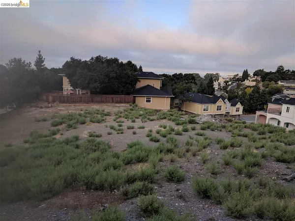 a view of a houses with a yard and mountain view