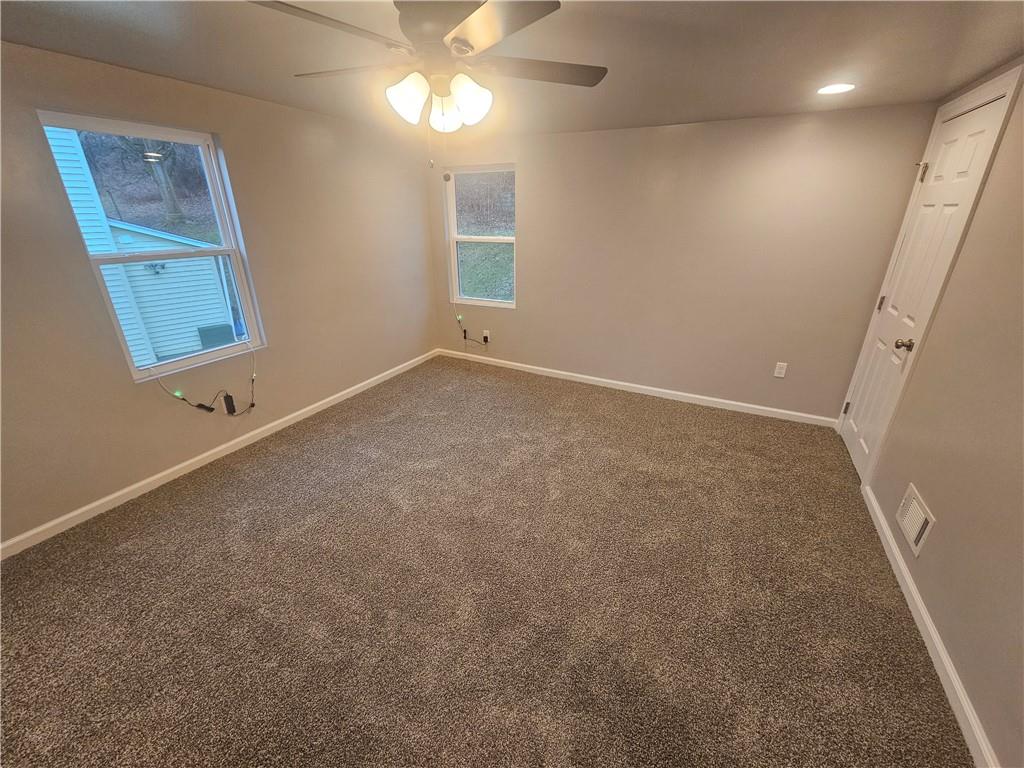 17 Hemlock Street Ellsworth, PA 15314 - Photo 8 of 9 en empty room with windows and fan