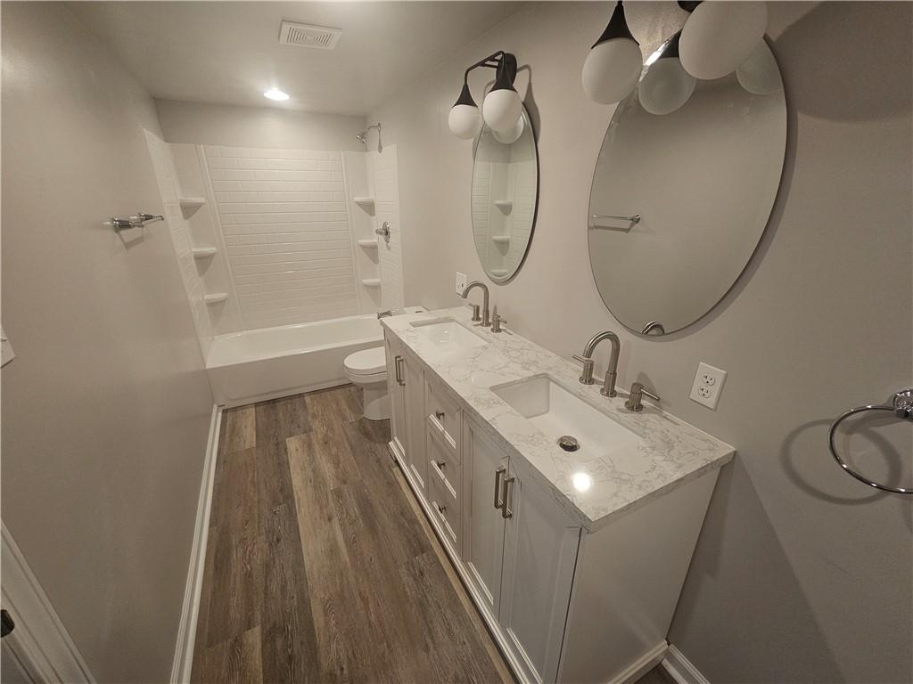 17 Hemlock Street Ellsworth, PA 15314 - Photo 9 of 9 a bathroom with a sink a mirror and a shower