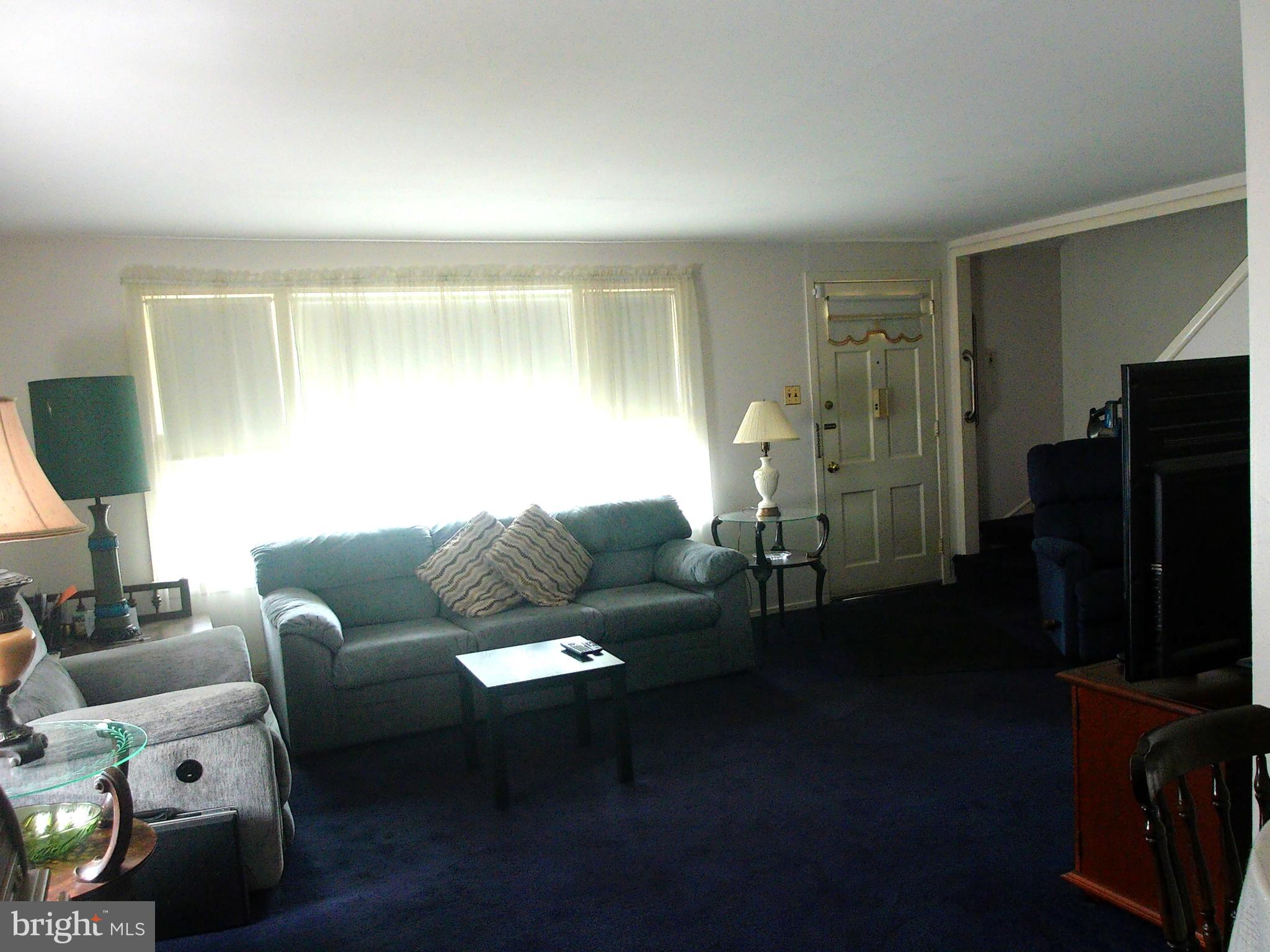 1709 Church Road Oreland, PA 19075 - Photo 5 of 40 a living room with furniture and a flat screen tv