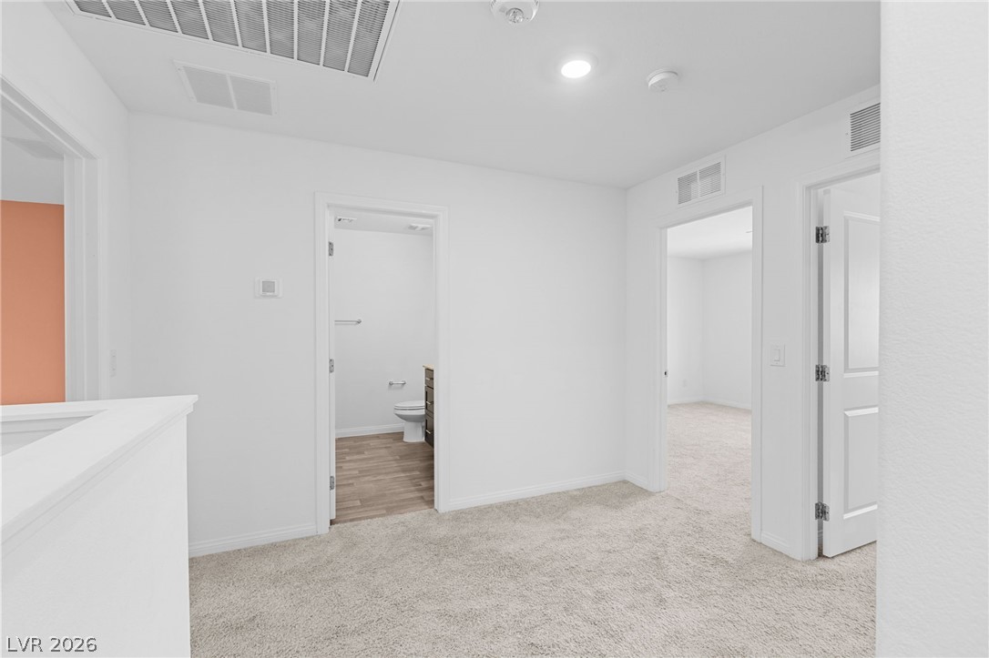 12367 Indigo Montage Road, Unit 3 Las Vegas, NV 89183 - Photo 19 of 33 This interior hallway offers easy access to adjacent rooms, enhancing the flow of the home.