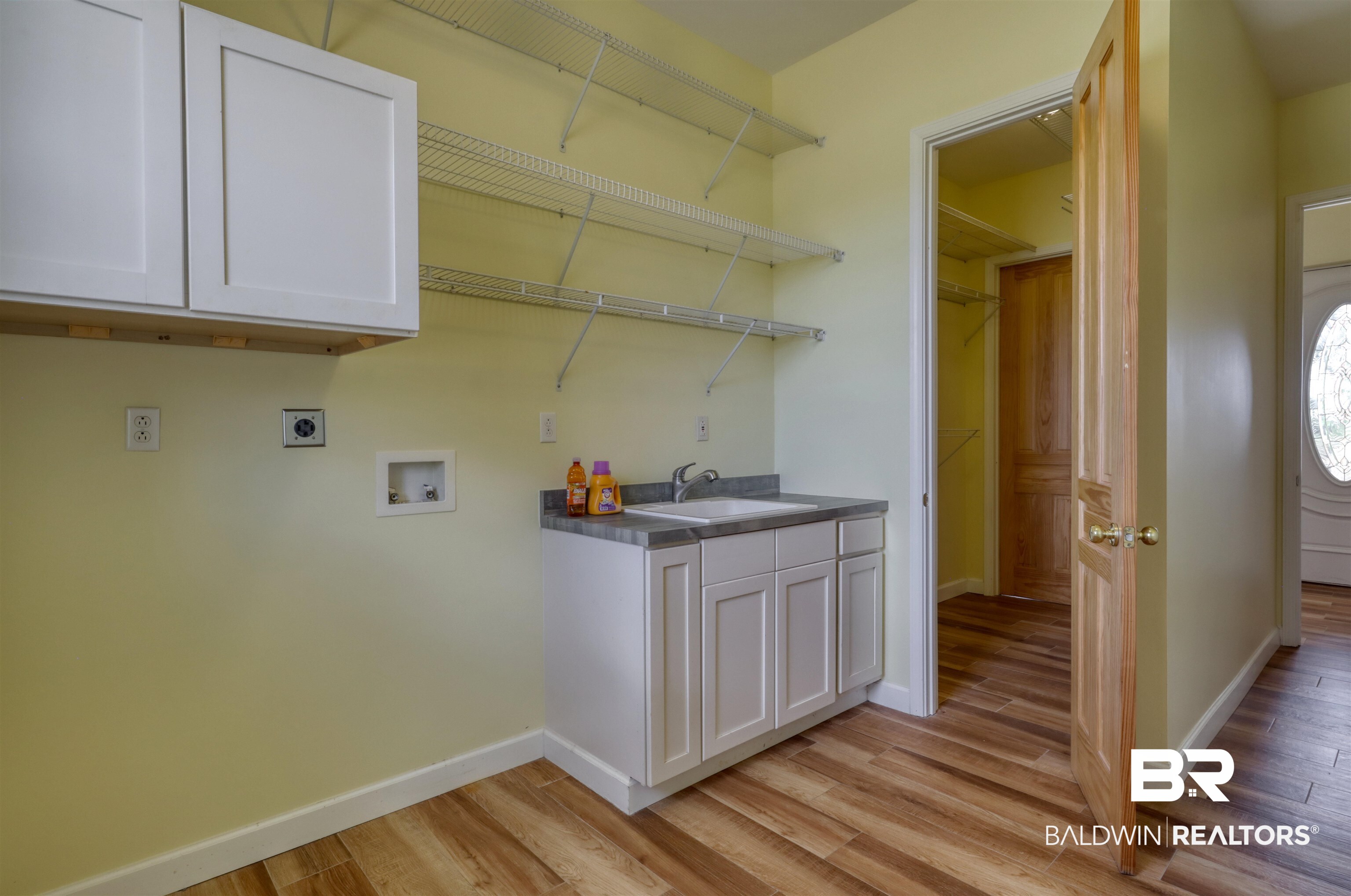 28461 Gardner Road Elberta, AL 36530 - Photo 8 of 46 Laundry area featuring cabinet space, light wood-style floors, washer hookup, and hookup for an electric dryer