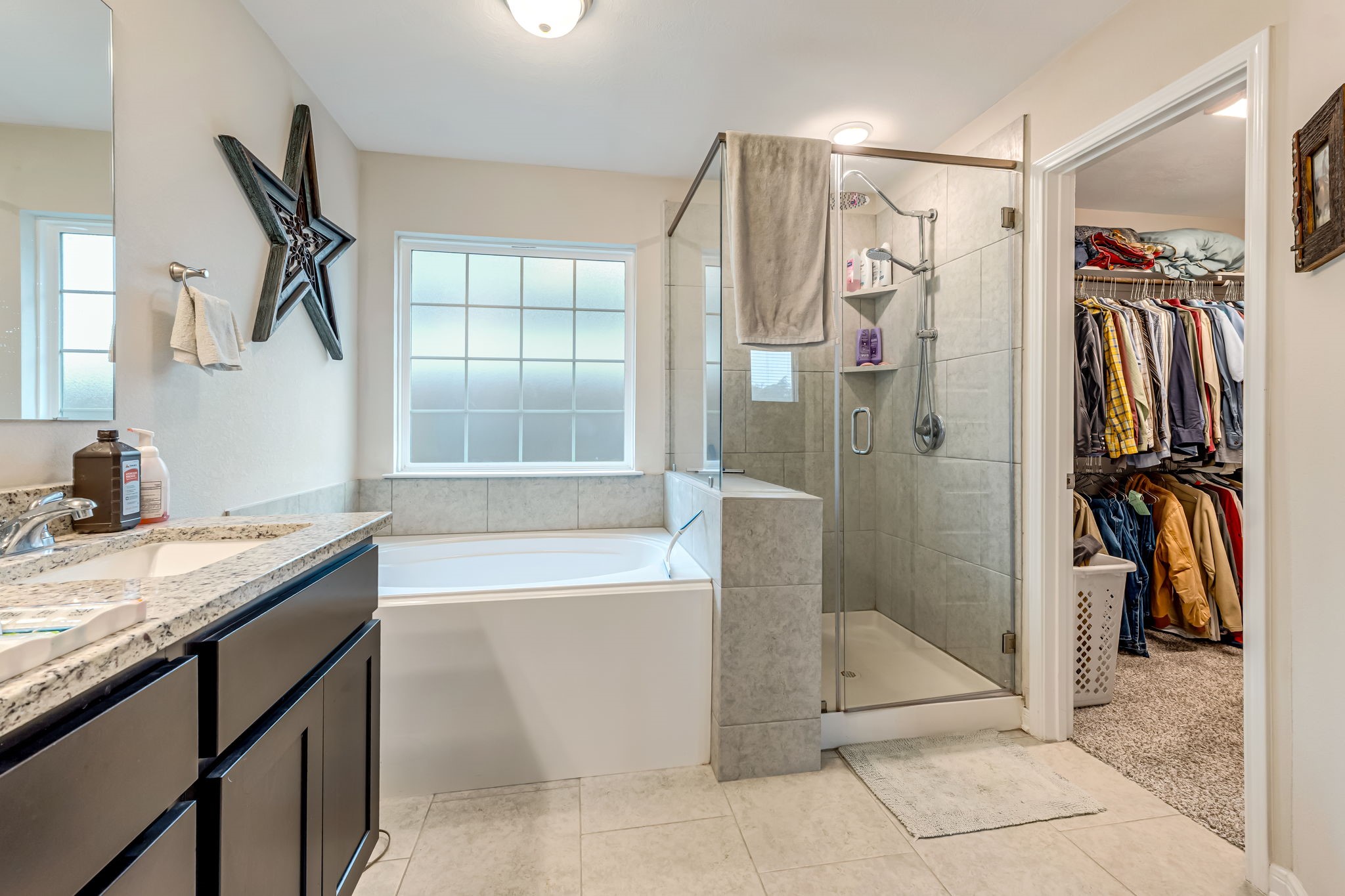 1946 Chief Street Bryan, TX 77807 - Photo 21 of 30 a bathroom with a granite countertop sink a toilet and a shower