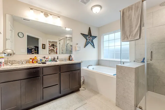 a bathroom with a granite countertop sink a toilet and a shower curtain