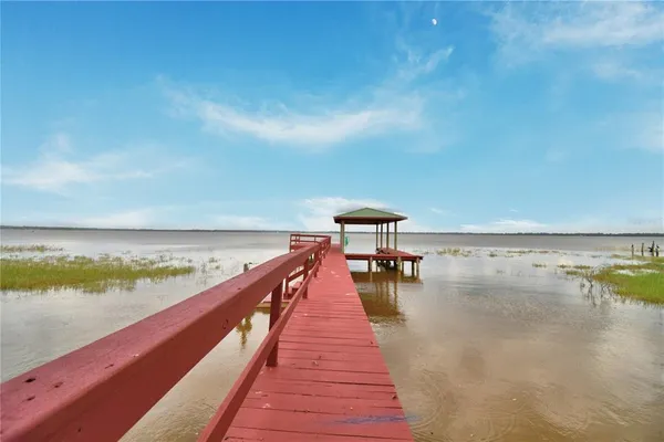 a view of a livingroom with breakfast area and chandelier