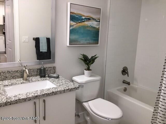 2760 Bosque Circle, Unit 307 Melbourne, FL 32940 - Photo 12 of 18 a bathroom with a granite countertop sink a toilet and bathtub