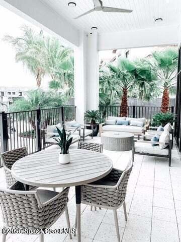 2760 Bosque Circle, Unit 307 Melbourne, FL 32940 - Photo 15 of 18 a view of a dining table and chairs in the patio