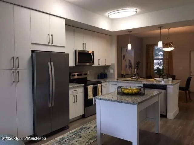 a kitchen with a refrigerator and a stove