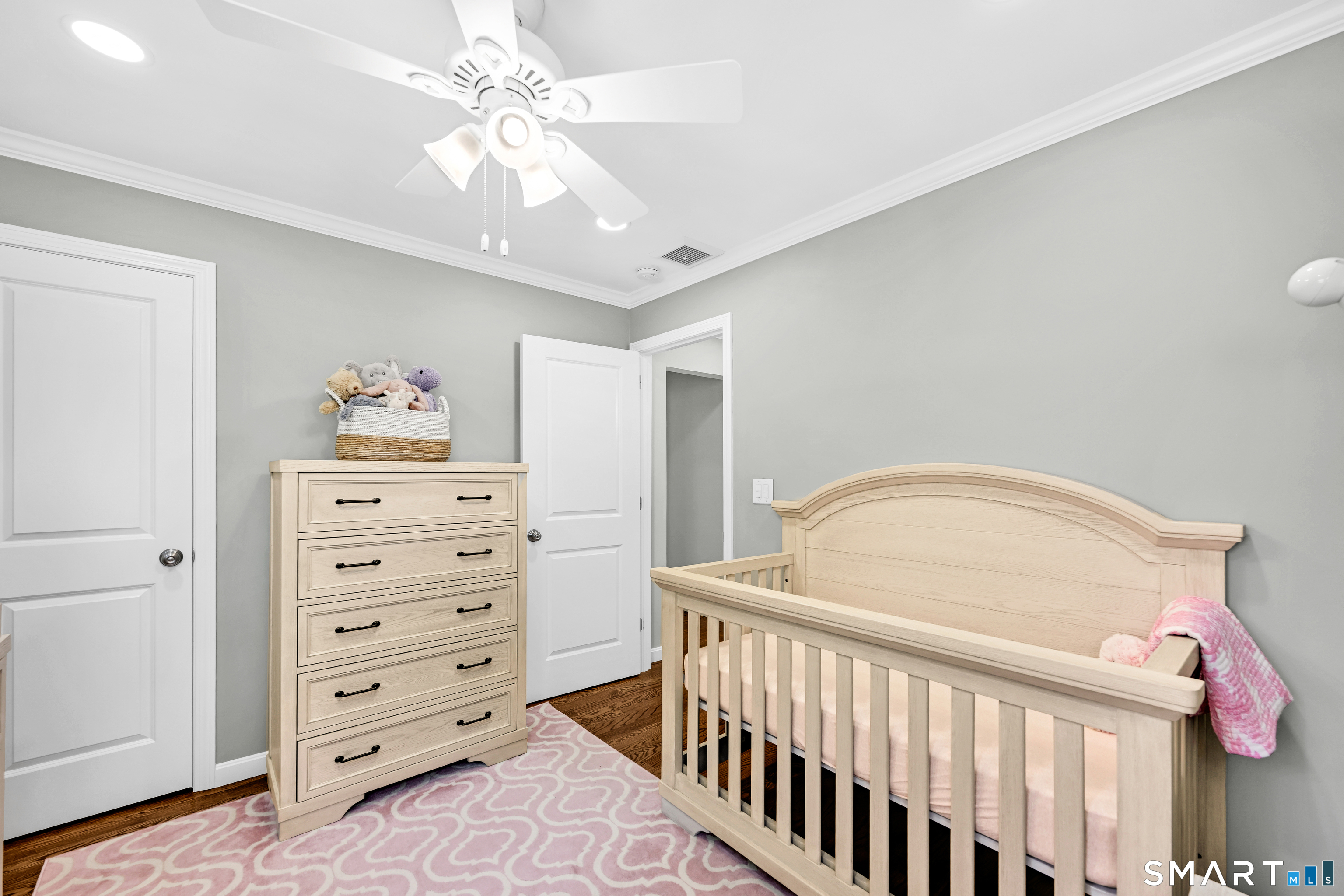 87 Lydall Road Newington, CT 06111 - Photo 18 of 35 a bedroom with a baby bed a chandelier and closet