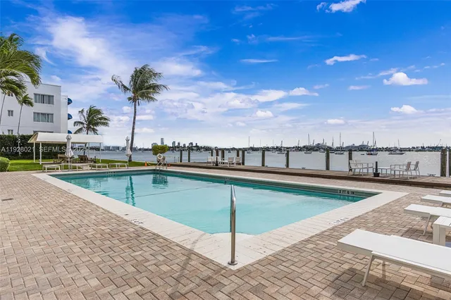 a view of outdoor space with swimming pool and seating