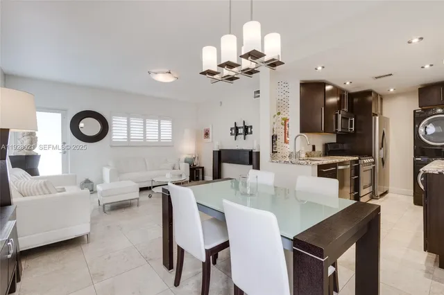 a view of a dining room with furniture and a chandelier