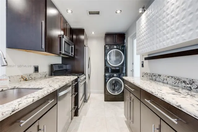 a kitchen with a sink a stove and cabinets