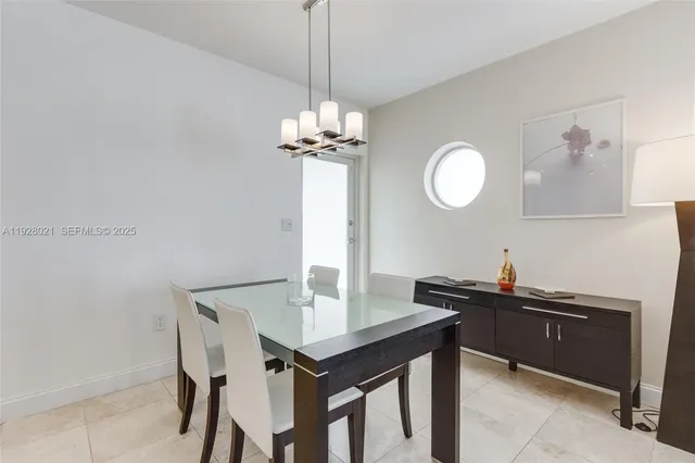 a view of a dining room with a table and chairs