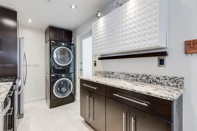 a view of a storage and utility room with washer and dryer