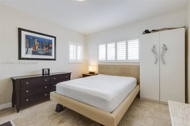 a bedroom with a bed and a cabinet