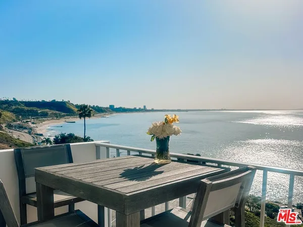 a view of a tables and chairs on the roof deck