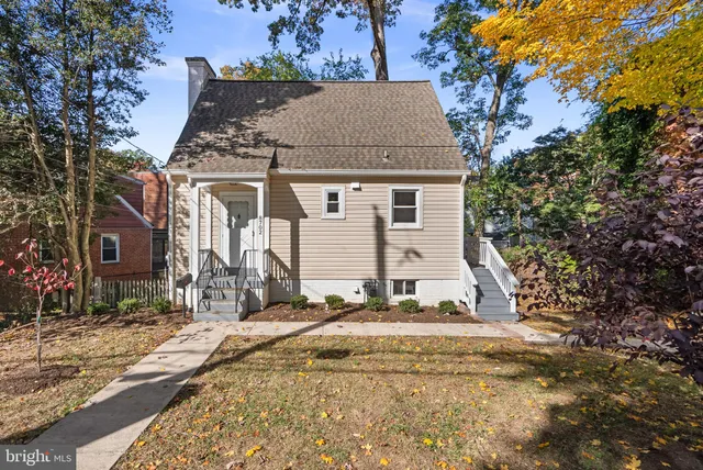 a view of a house with a yard and tree s
