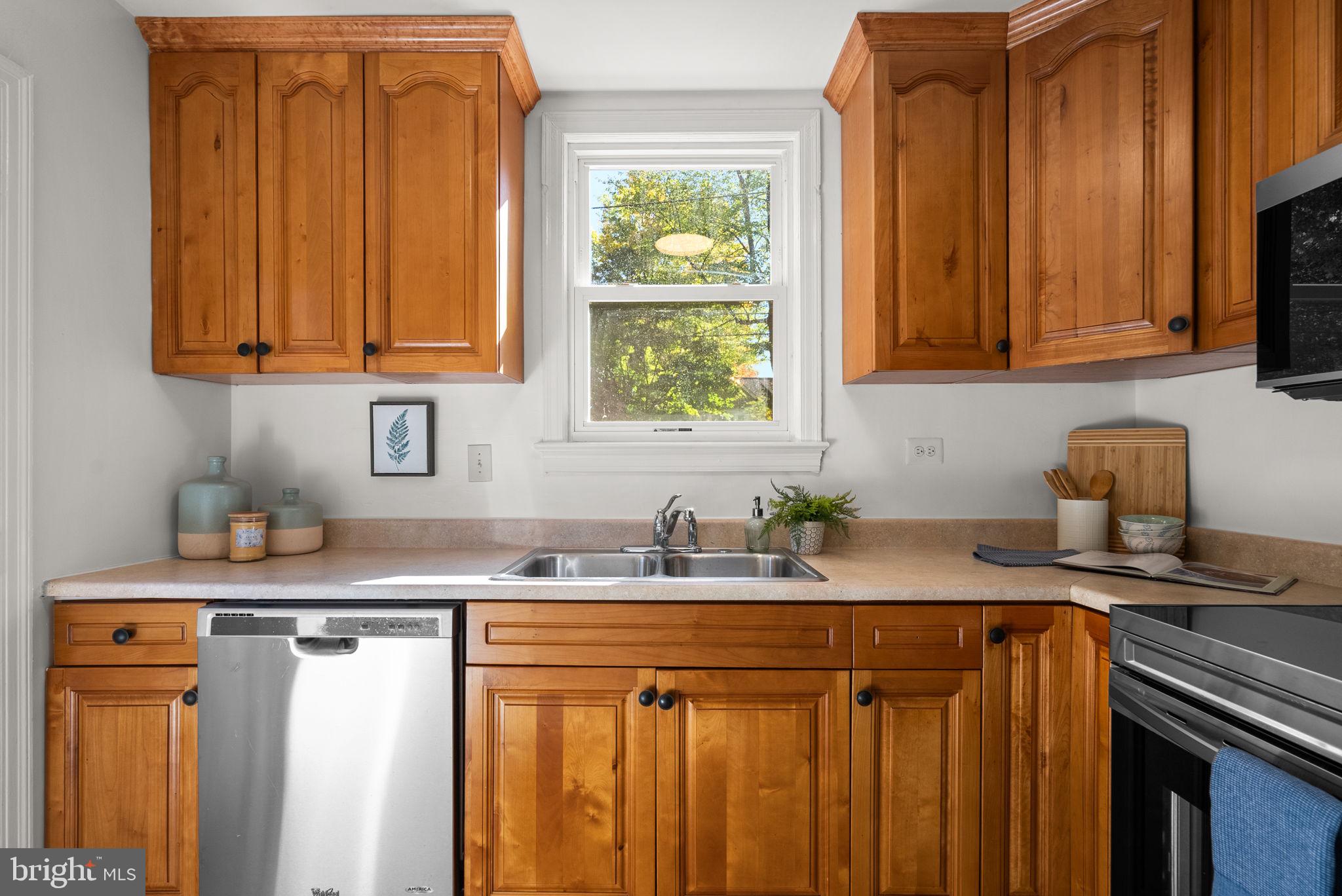 8702 Reading Road Silver Spring, MD 20901 - Photo 14 of 42 a kitchen with stainless steel appliances granite countertop a sink stove and cabinets