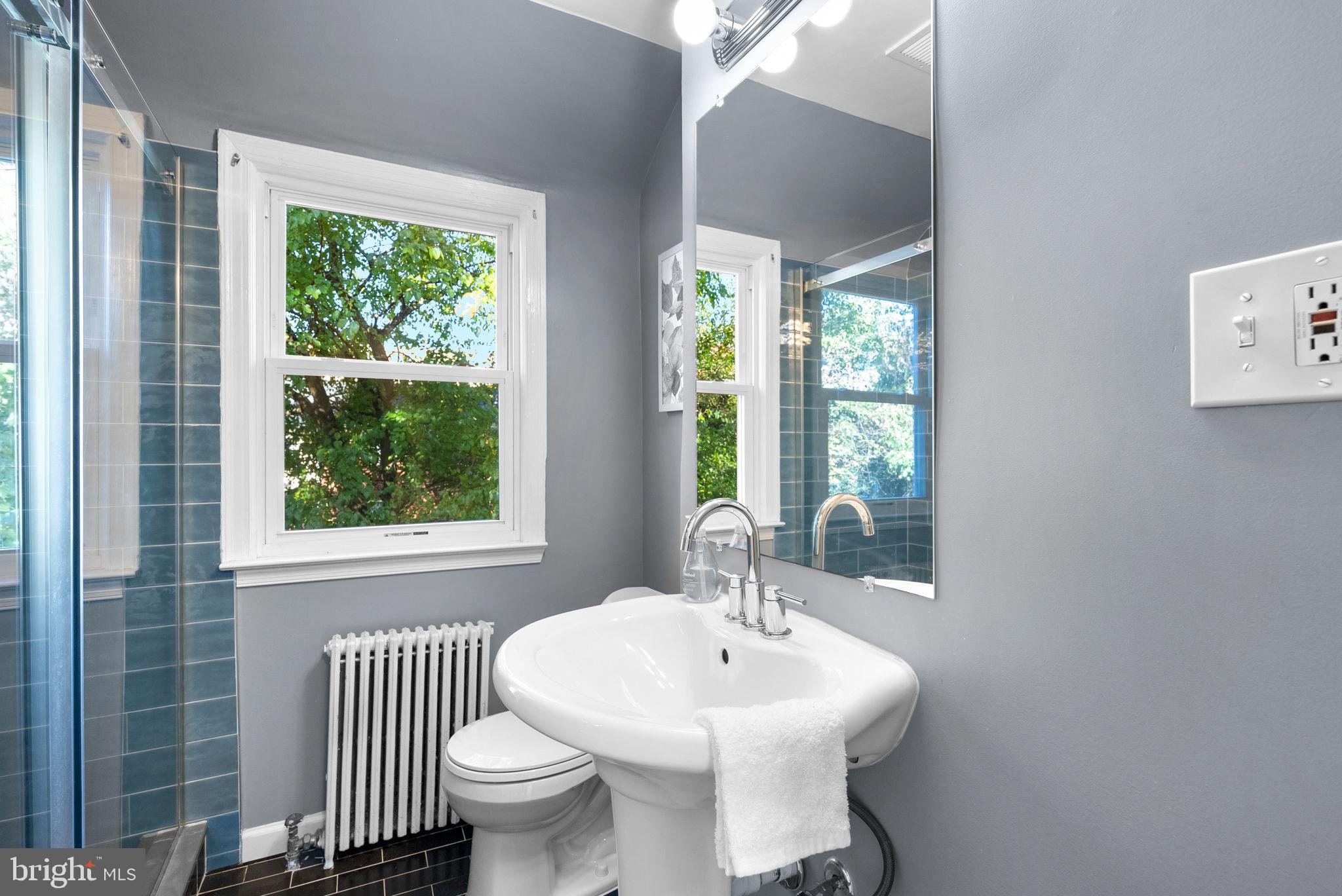 8702 Reading Road Silver Spring, MD 20901 - Photo 22 of 42 a bathroom with a sink toilet and a mirror