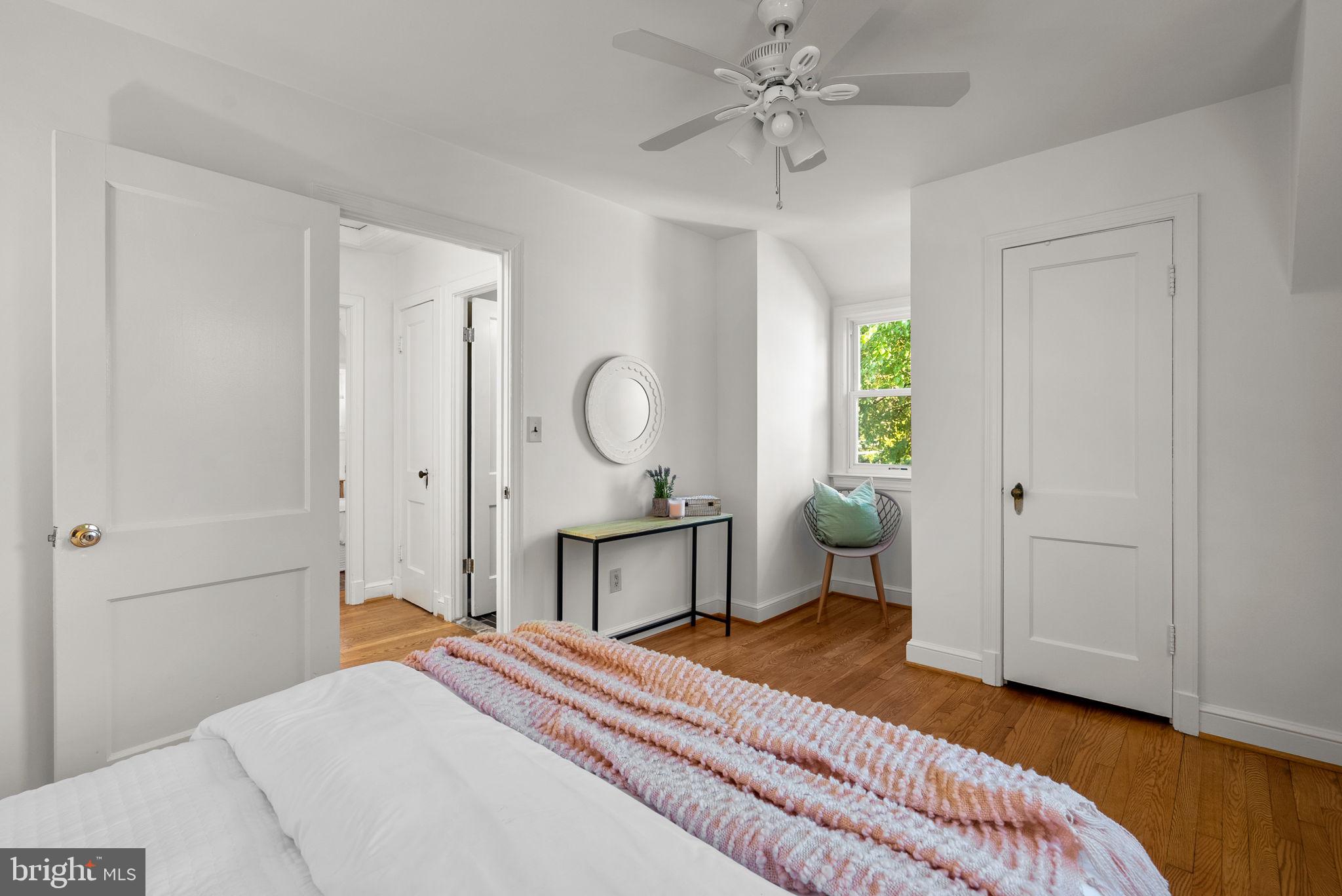 8702 Reading Road Silver Spring, MD 20901 - Photo 26 of 42 a bedroom with a bed a chandelier and mirror