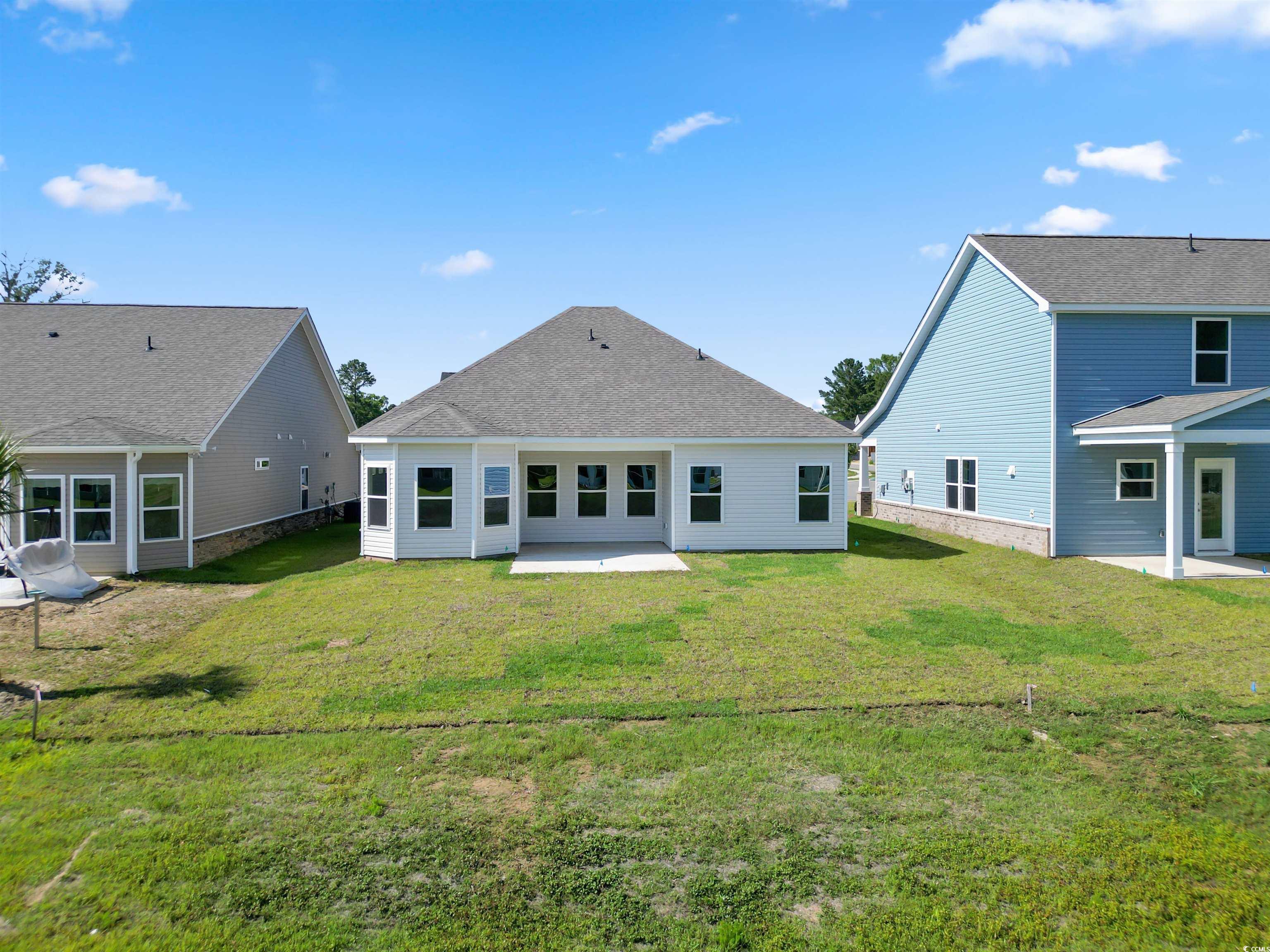 2427 Campton Loop Conway, SC 29527 - Photo 4 of 40 Back of house with a patio and a lawn