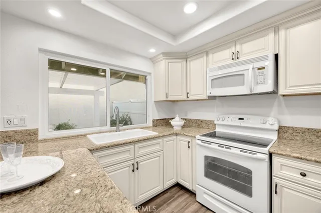 a kitchen with a stove a sink and a microwave