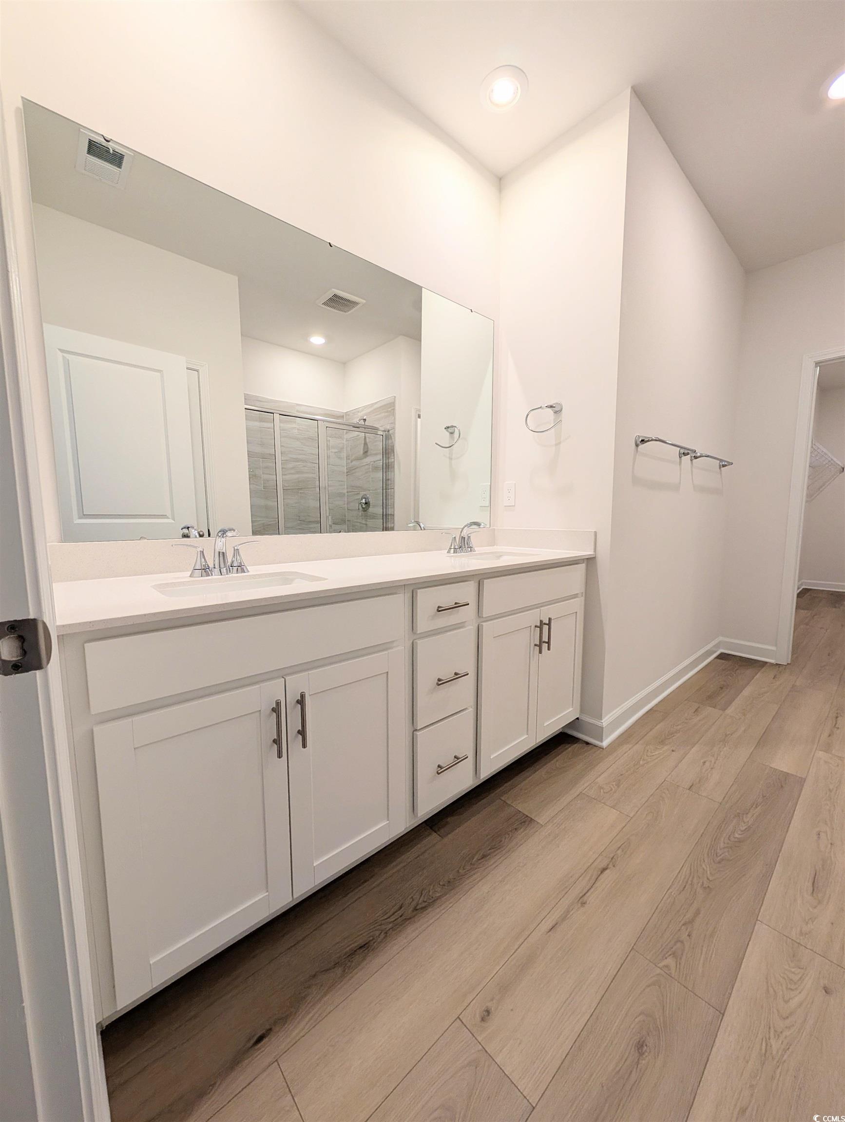1109 Lauryn Oak Loop Longs, SC 29568 - Photo 17 of 40 Bathroom featuring light wood-style flooring, double vanity, a stall shower, recessed lighting, and a spacious closet