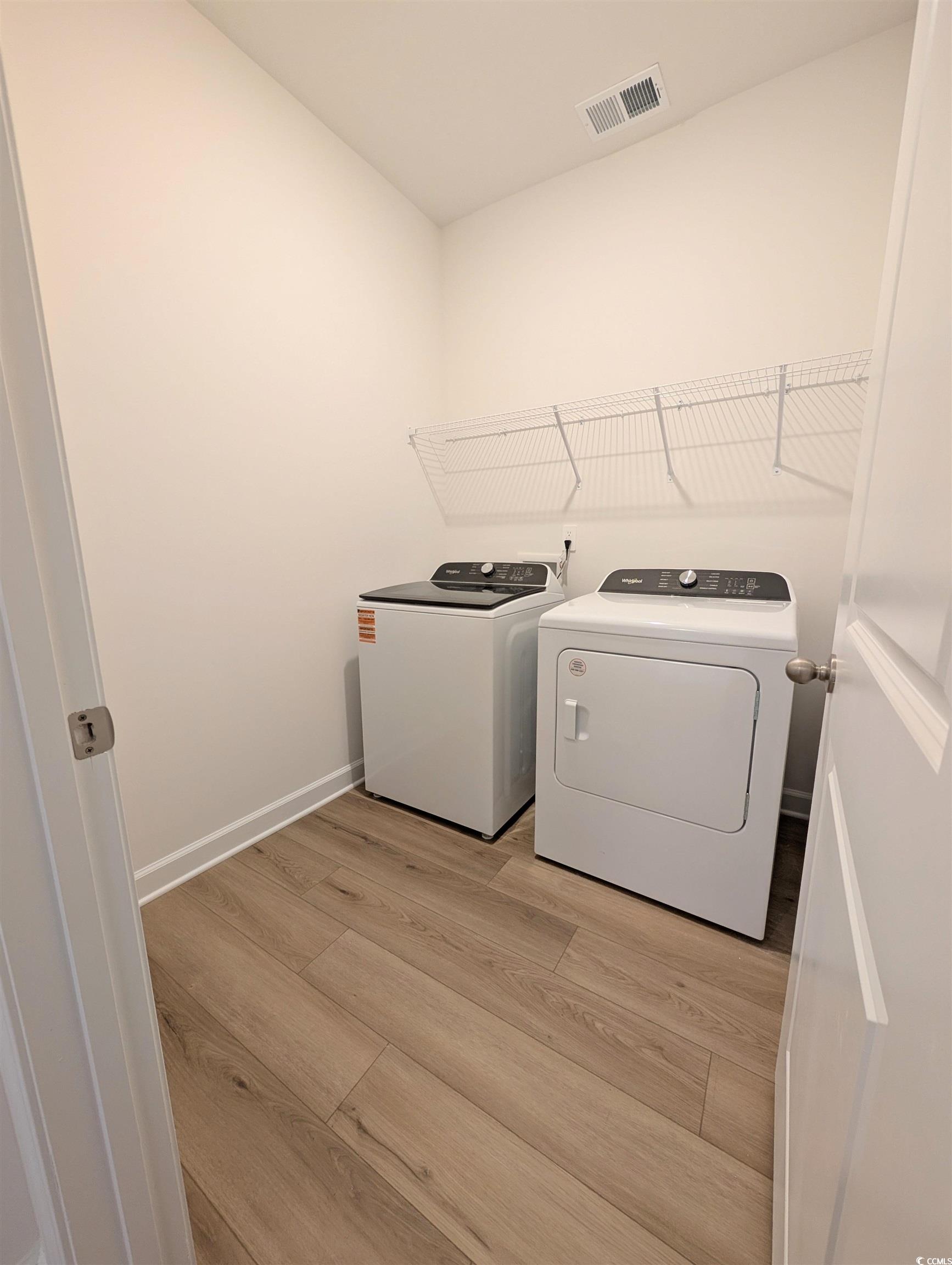 1109 Lauryn Oak Loop Longs, SC 29568 - Photo 31 of 40 Laundry room featuring light wood-style flooring and washing machine and clothes dryer
