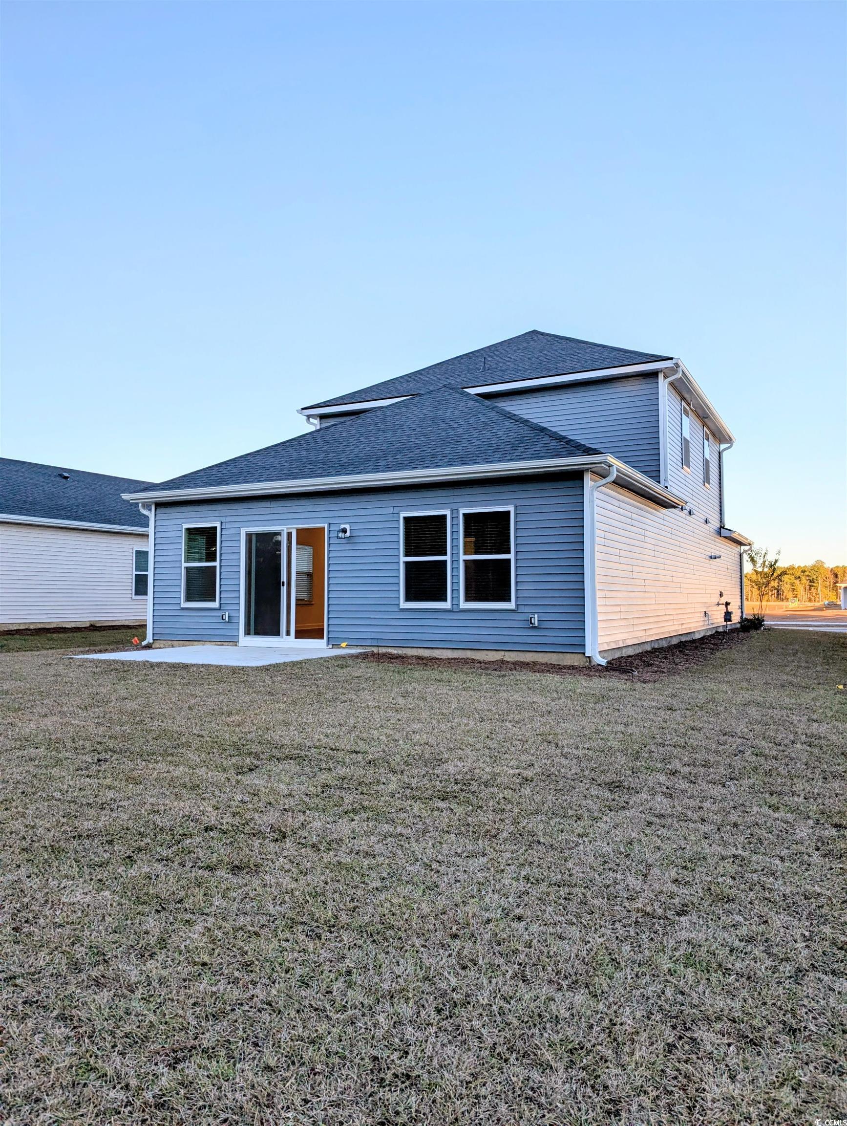 1109 Lauryn Oak Loop Longs, SC 29568 - Photo 36 of 40 Rear view of house featuring a patio, a lawn, and a shingled roof