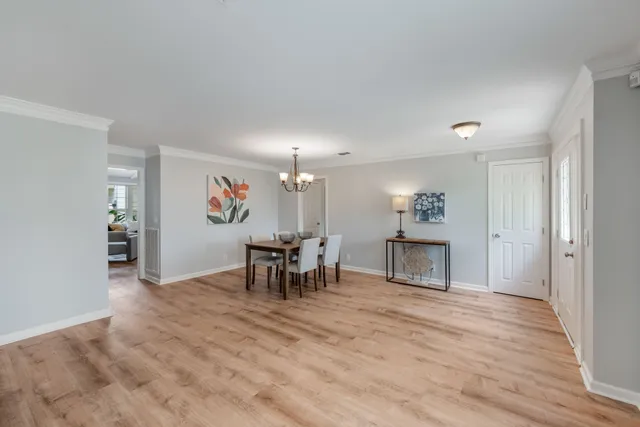 a view of a room with furniture and a table chair