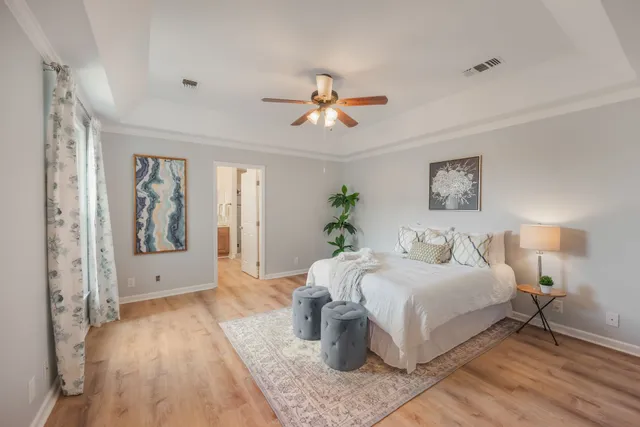 a bedroom with a large bed and a chandelier