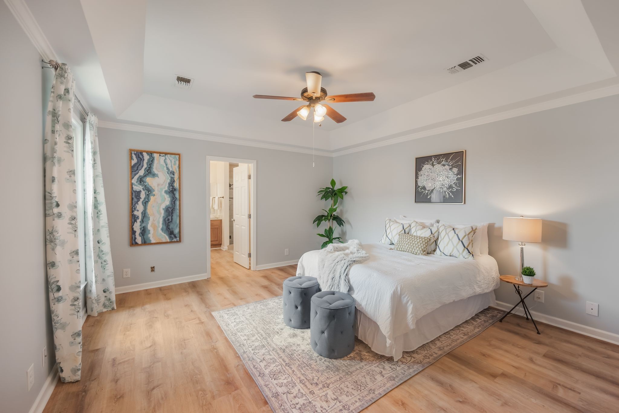 1281 General George Patton Road Nashville, TN 37221 - Photo 18 of 32 a bedroom with a large bed and a chandelier