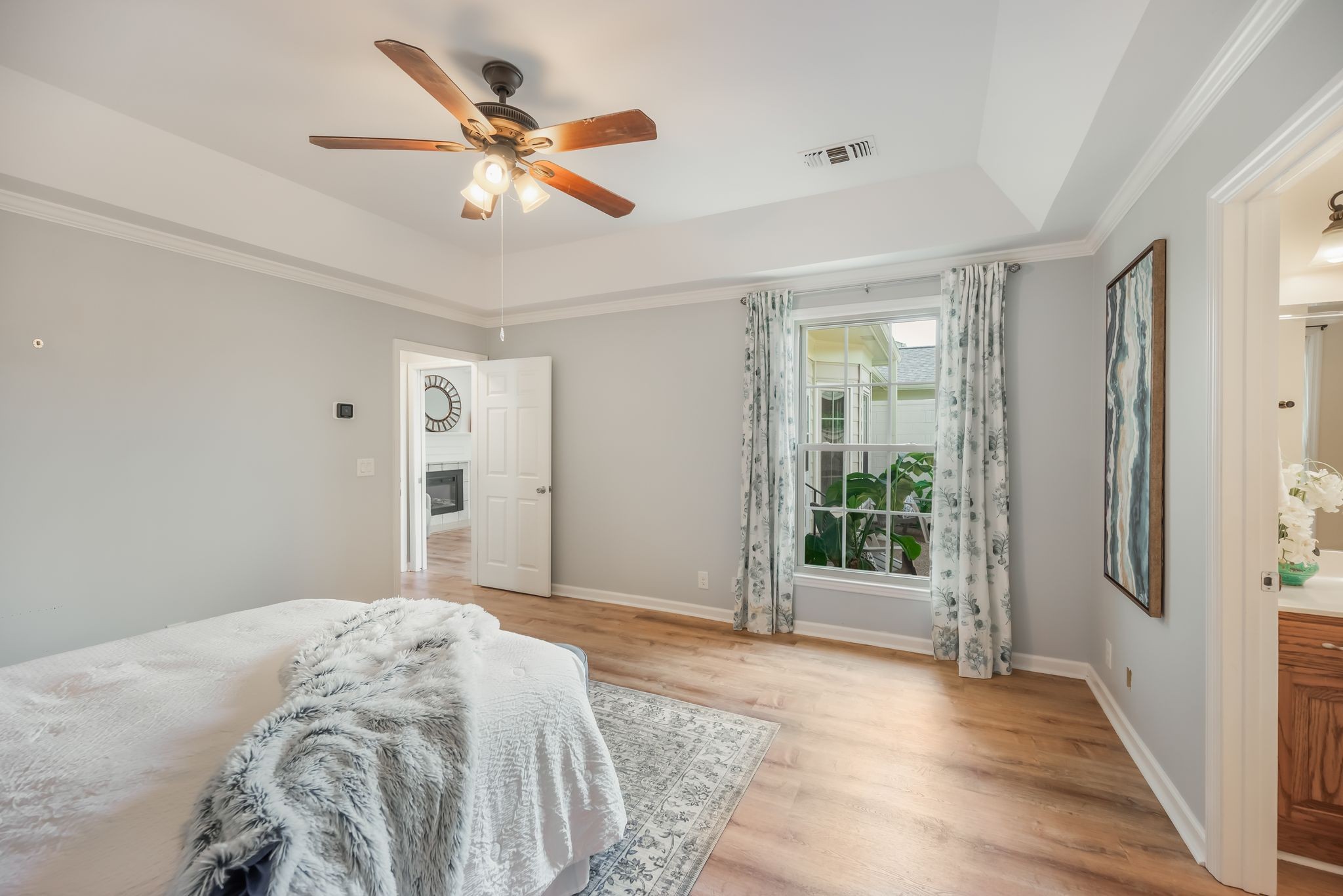 1281 General George Patton Road Nashville, TN 37221 - Photo 19 of 32 a bedroom with a large bed and a chandelier fan