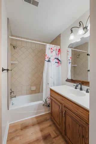 a bathroom with a sink vanity tub and a mirror