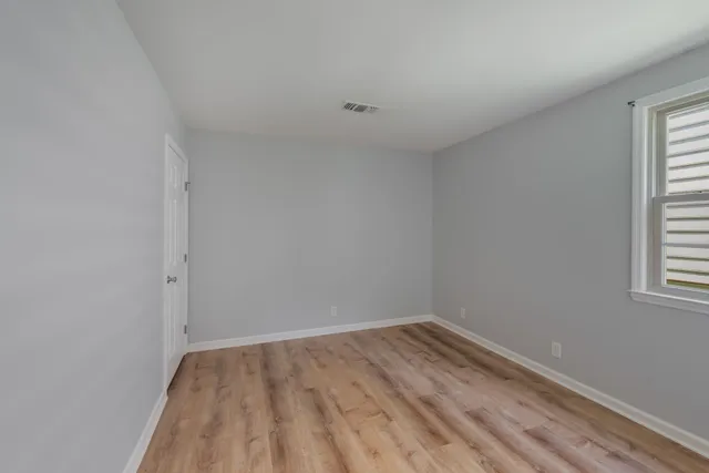a view of room with window and hardwood floor