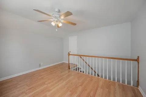 a view of a room with wooden floor