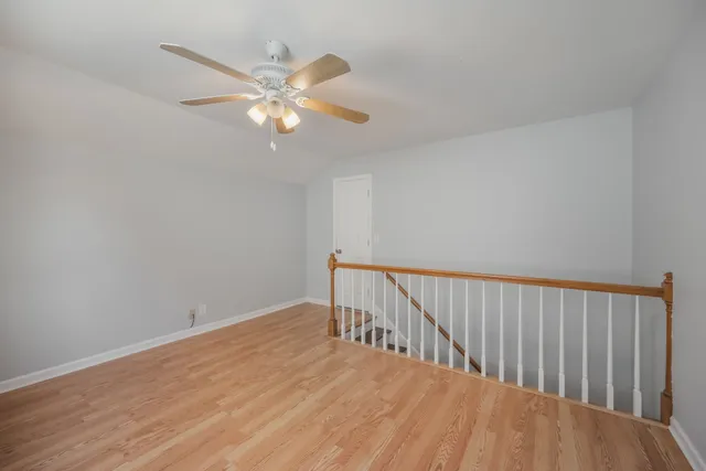 a view of a room with wooden floor