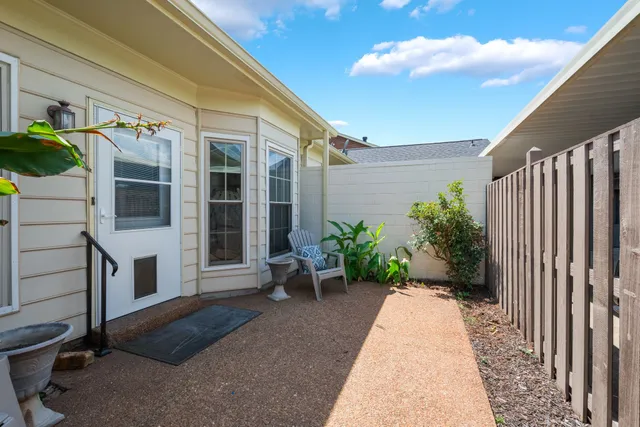 a view of a house with potted plants