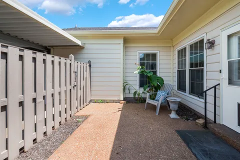 a view of a patio with table and chairs and wooden floor